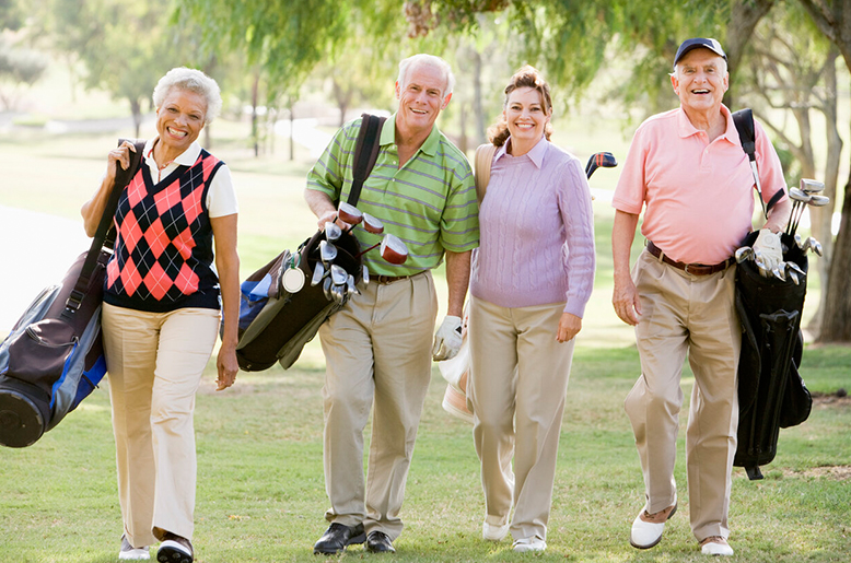 Seniors strolling on the golf course of an active living community