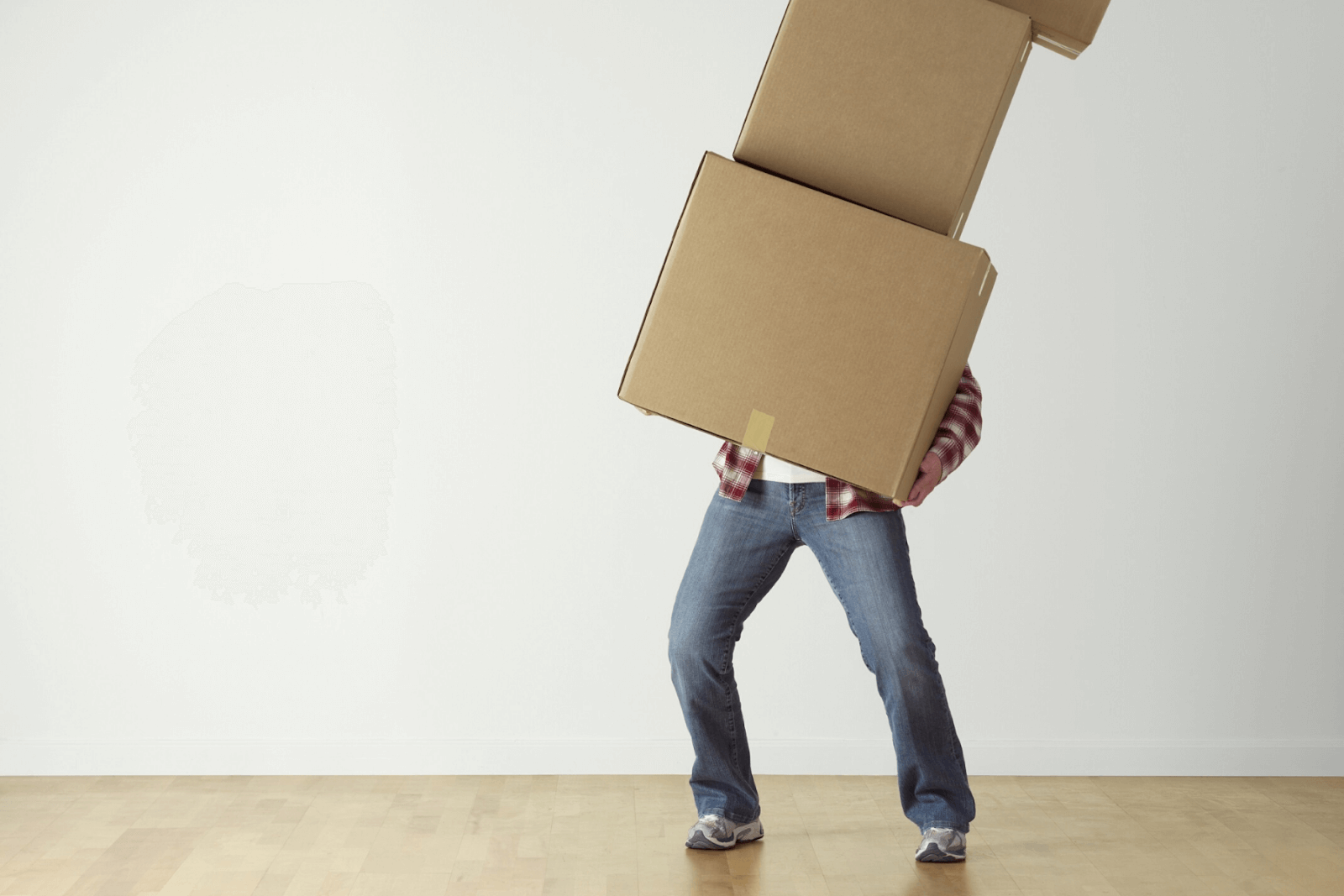 A man trying to move boxes by himself