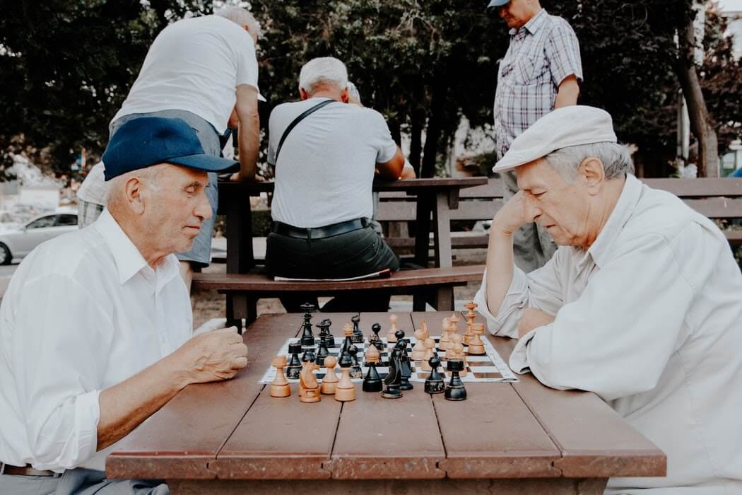 Two elderly men playing a game of chess